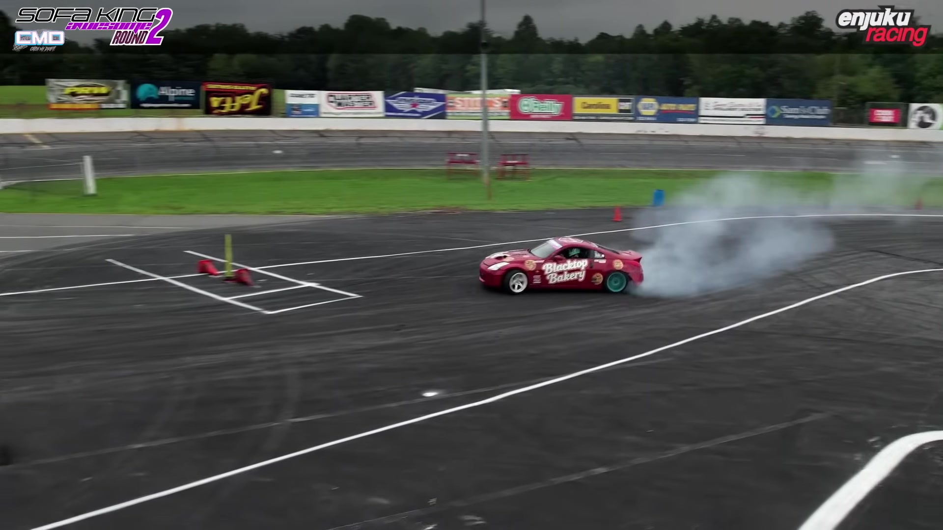 Joe Busam's red Blacktop Bakery Nissan 350Z drifting during Round 2 qualifying at Hickory Motor Speedway