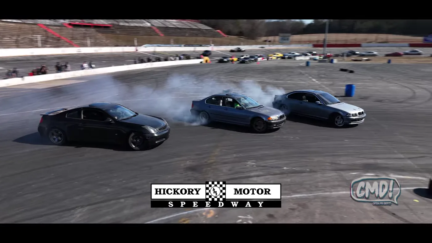 Three CMD cars sliding together during an open drift session